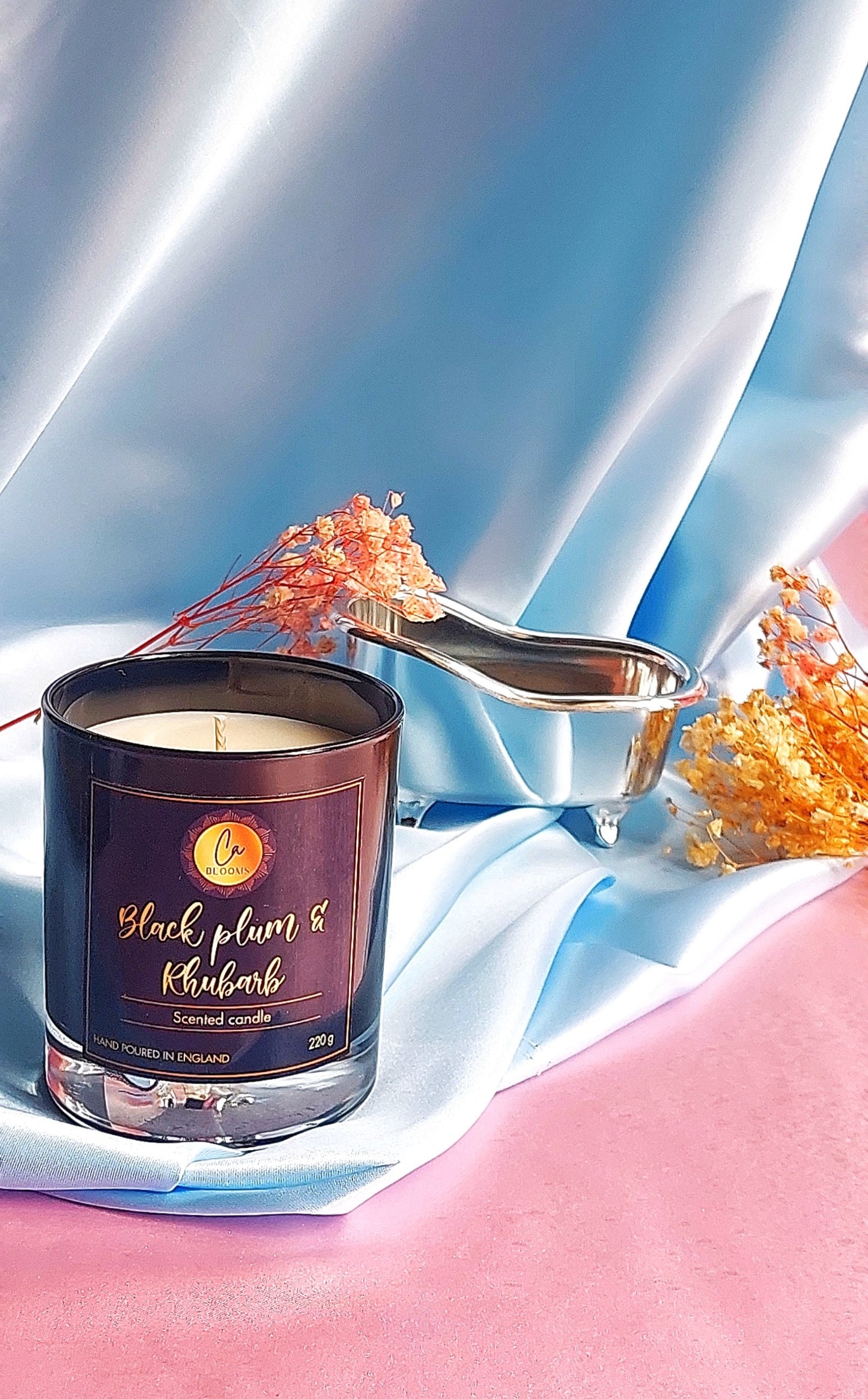 Black plum and rhubarb scented candle in gloss black candle jar